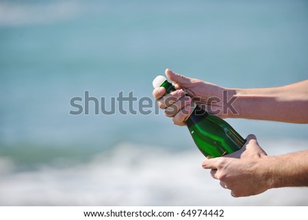 man hands open bottle of champagne alcohol and wine drink outdoor on party celebration event