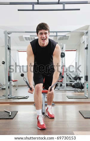 young man in fitness sport club exercise with weights and relaxing