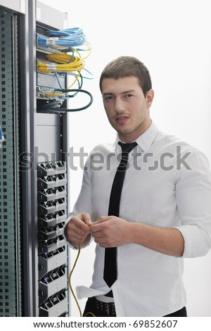 young handsome business man it  engeneer in datacenter server room