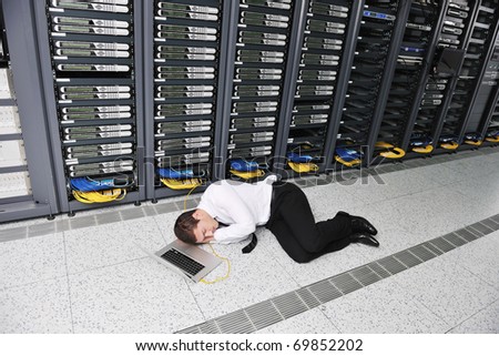 young it  engeneer business man with thin modern aluminium laptop in network server room