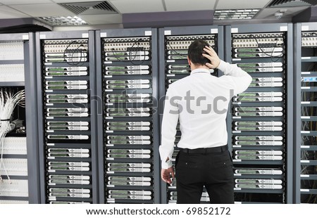 it business man in network server room have problems and looking for  disaster situation  solution