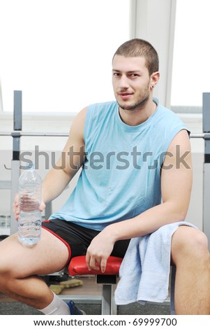 young man drink water at fitness workout training at sport club