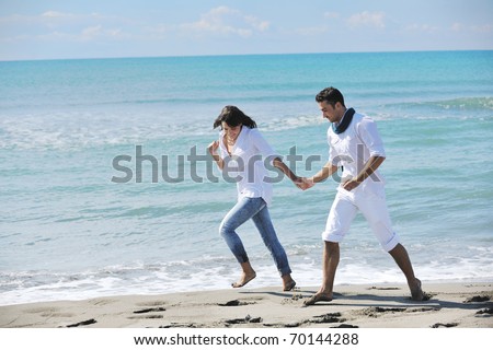 happy young couple in white clothing  have romantic recreation and fun at beautiful beach on vacations