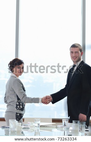 business man and woman handshake on successful  meeting at bright office conference room indoor