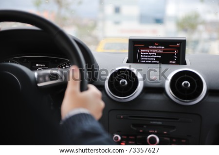 young man using new car navigation and onboard vehicle transport system