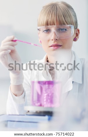doctor student  female researcher holding up a test tube in chemistry bright labaratory
