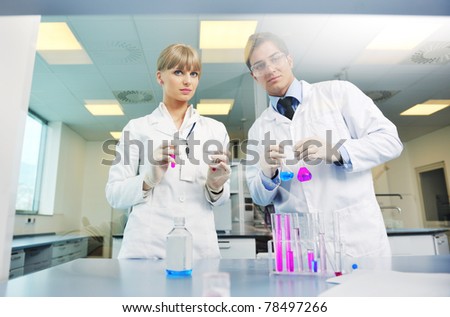 science and research biology chemistry an dmedicine  youn people couple in bright modern  lab