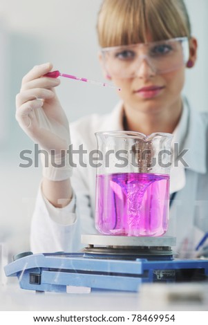 doctor student  female researcher holding up a test tube in chemistry bright labaratory