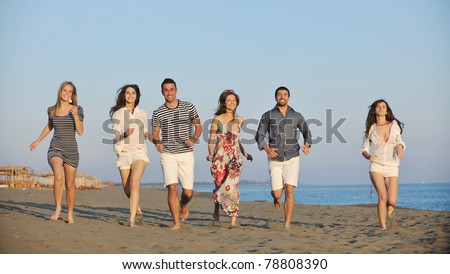 happy young people group have fun  run and jump  on beach beautiful sand  beach