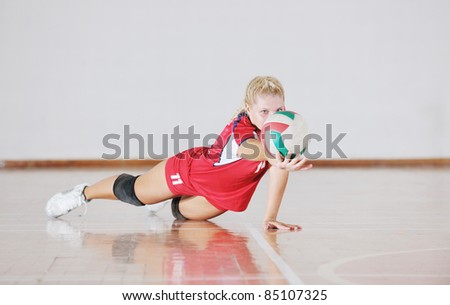 one young girl playing volleyball game sport  indoor