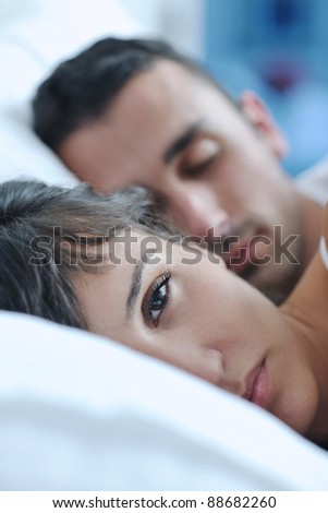 happy young healthy people  couple have good time in their bedroom make love and sleep