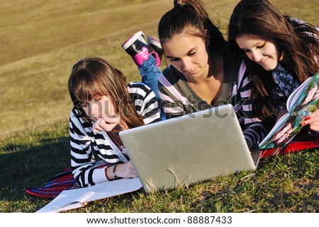 group of teen girl woman outdoor have fun and study homework on laptop computer