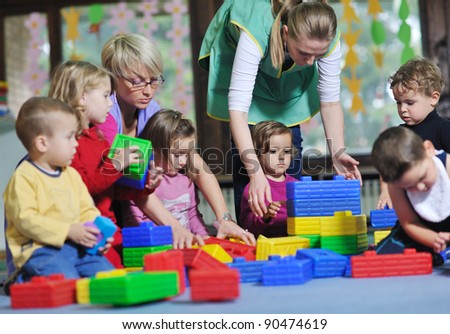 happy child kids group have fun and play at kindergarden indoor preschool education concept with  teacher