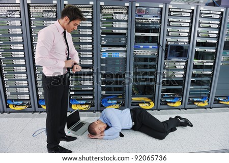 it business man in network server room have problems and looking for  disaster situation  solution
