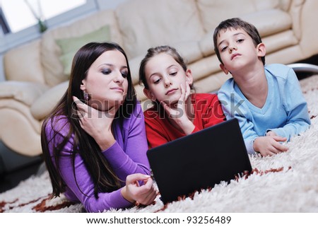 happy young family with mom and kids have fun and play in modern new living room home indoor