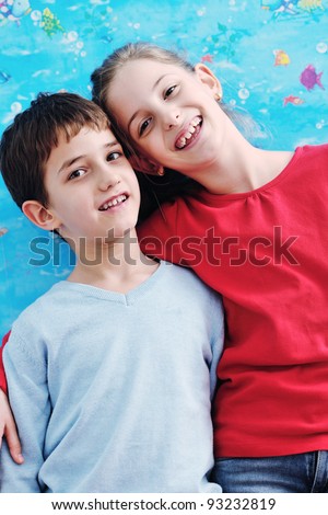 happy child kids portrait at home brother and sister hug and have fun and joy