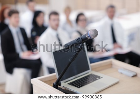 business laptop and microphotone at podium on seminar conference education