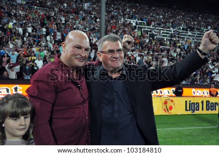CLUJ NAPOCA, ROMANIA MAY 20: FC CFR Cluj soccer club owner and businees man, Arpad Paszkany (L) and club manager Iuliu Muresan (R) celebrating the league title , on MAY 20, 2012 in Cluj N, Romania