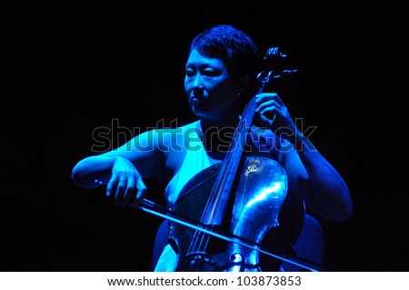 CLUJ NAPOCA, ROMANIA Ã¢Â?Â? MAY 29: Pansy Chang from Pink Martini pop-jazz band performs live on cello at the Sports Hall of Cluj, Romania, MAY 29, 2012 in Cluj-Napoca, Romania