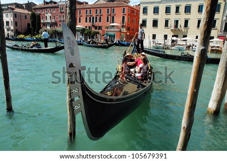 VENICE - AUGUST 29: Unidentified tourists visit the Grand canal. More than 21 million tourists visits Venice annually. On August 29, 2010 in Venice, Italy