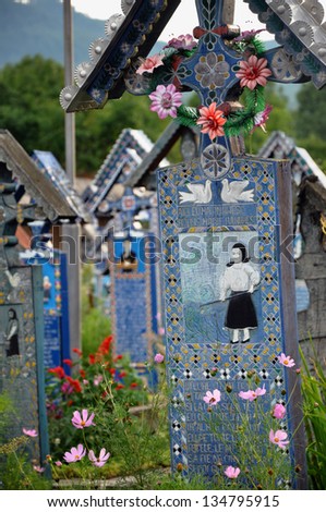 SAPANTA - JULY 21: Carved and painted wooden crosses in the Merry Cemetery, after the renovation. Part of UNESCO is visited by crowds of tourists every year. On July 21, 2013 in Sapanta, Romania