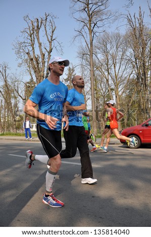 CLUJ NAPOCA - APRIL 21: Unidentified participants at the Cluj International Marathon running through the city of Cluj Napoca, on April 21, 2013 in Cluj Napoca, Romania