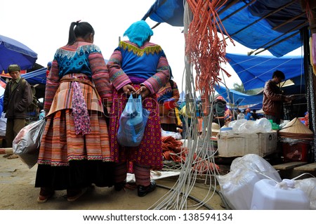 BAC HA - FEB 23: Unidentified women selling textiles in Bac Ha market. The market is a must see destination for every traveler in Vietnam. On Feb 23, 2013 in Bac Ha, Sa Pa, Vietnam