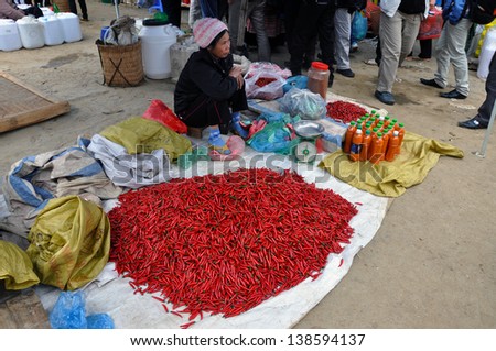 BAC HA - FEB 23: Unidentified woman selling chili in Bac Ha market. The market is a must see destination for every traveler in Vietnam. On Feb 23, 2013 in Bac Ha, Sa Pa, Vietnam