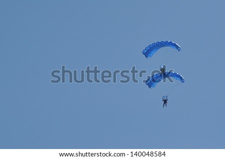 CLUJ NAPOCA, ROMANIA - MAY 18: Parachutists from the Romanian Aeroclub Team and the Romanian Air Force Army jumping on the Romanian Air Fest on May 18, 2013 in Cluj Napoca, Romania