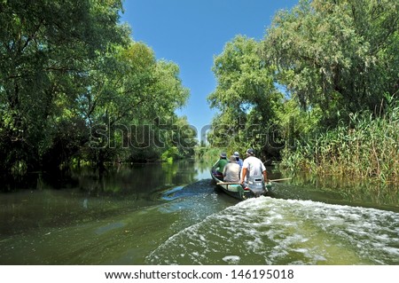SULINA - JUNE 25:Unidentified tourists take boat trip with a local guide in the Danube Delta Biosphere Reserve. Danube delta is the second largest river delta in Europe. On June 25 in Sulina,Romania