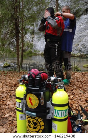 ARIES - CIRCA JUNE: A cave diver emerges from the Tauz spring, after exploring the cave. Cave diving is a very dangerous sport and means of exploration and research circa June 2009 in Aries, Romania