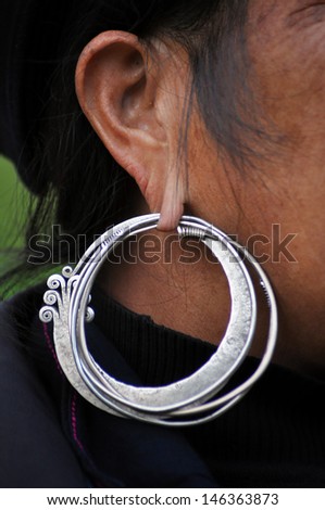 SA PA, VIETNAM - FEB 22: An unidentified old Black H'mong woman with a silver earring. The H'mong people are one of the largest ethnic minorities in Vietnam.  On Feb. 22, 2013 in Sapa, Vietnam