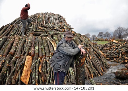 LUPENI, ROMANIA - APRIL19: An unidentified man works in charcoal production on April 19, 2012 in Lupeni, Romania. The charcoal produced here has the highest quality in Europe and is exported worldwide