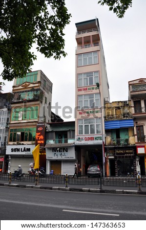 HANOI - FEB 19: Tall and narrow buildings standing side by side in Hanoi. The reason for this is the way people are taxed on property, by the width of the front. On Feb. 19, 2013 in Hanoi, Vietnam