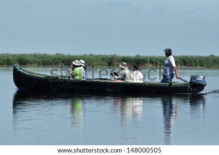 GORGOVA- JUNE 25:Unidentified tourists take boat trip with a local guide in the Danube Delta Biosphere Reserve. Danube delta is the second largest river delta in Europe. On June 25 in Gorgova,Romania