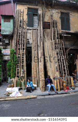 HANOI - FEB 19: Unidentified street sellers selling bamboo. In the communist Hanoi as a result of Doi Moi, privately owned enterprises were permitted in business. On Feb 19, 2013 in Hanoi, Vietnam