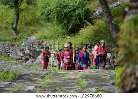 GHANDRUK, NEPAL - OCTOBER 6: A group of Gurung women going to work in the mountains. Gurungs are the biggest ethnic group in the Himalayas. On October 6, 2013 in Ghandruk, Nepal