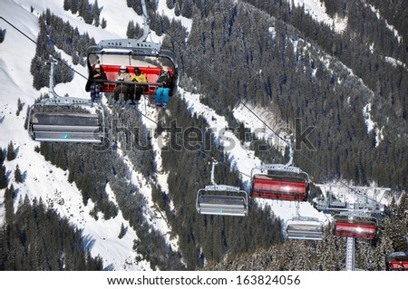 KAPRUN, AUSTRIA - CCA. MARCH: Unidentified skiers going up with a ski lift and enjoying the last ski week of the season in the Austrian Alps. In March, 2012 in Zell am See, Austria