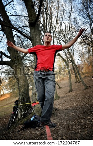 Man balancing on the slack line in the outdoor