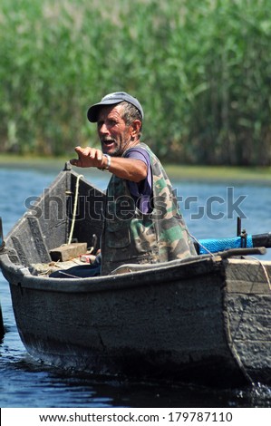 DANUBE DELTA, ROMANIA - JUNE 25: Unidentified local fisherman fishing in the Danube delta. Fishing is a necessity for local people for the everyday food. On June 25, 2013, in Sulina, Romania