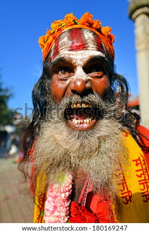 KATHMANDU, NEPAL - OCTOBER 8: Holy Sadhu man with long beard and traditional painted face at the Durbar square. On October 8, 2013 in Kathmandu, Nepal