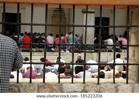 SARAJEVO - AUGUST 7: Muslim men sit down during their daily praying in the central mosque in Sarajevo. On August 7, 2009 in Sarajevo, Bosnia and Herzegovina.