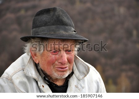 RAMET, ROMANIA - APRIL 6: Uncle Vasile, a 90 years old shepherd from Transylvania resting after a long walk with his sheeps. On April 6, 2014, in Ramet, Romania