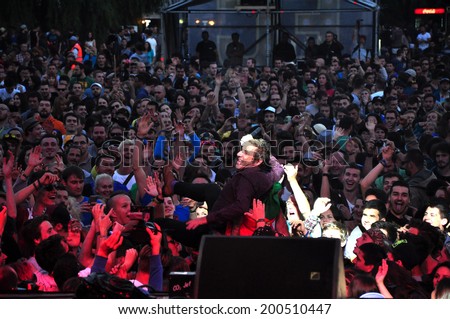 BONTIDA - JUNE 19: Crowd surfing of Barry Ashworth from Dub Pistols at Electric Castle Festival during a live concert at June 19, 2014 in the Banffy castle in Bontida, Romania