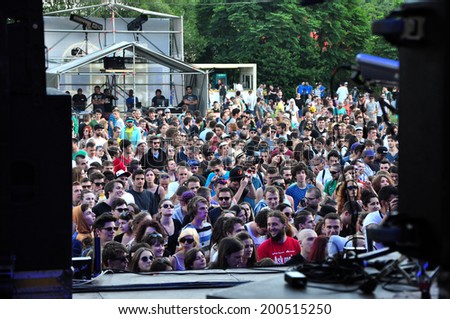 BONTIDA - JUNE 19: Crowd of partying people during a live concert at Electric Castle Festival on June 19, 2014 in the Banffy castle in Bontida, Romania.
