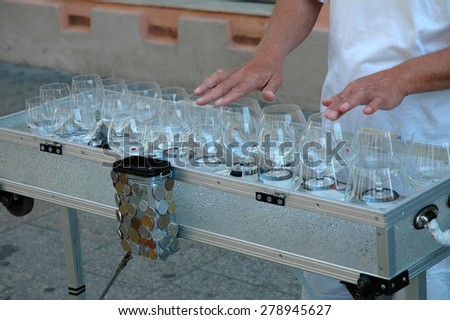 KRAKOW, POLAND - MAY 29: Street musician playing on a wine glass harp. The historical center of Krakow is full with artists and musicians. On May 29, 2005 in Krakow, Poland