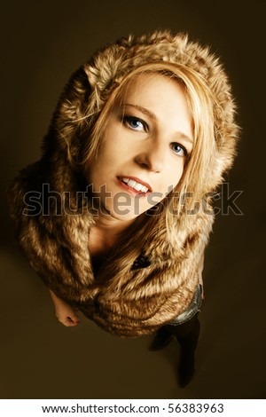 Young elegant girl with fur coat. Studio portrait