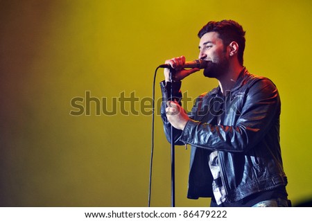 CLUJ NAPOCA, ROMANIA – OCTOBER 9: Andrei Tiberiu Maria from Smiley pop-rock band performs live at Cluj Arena Grand Opening concert on October 9, 2011 in Cluj-Napoca, Romania
