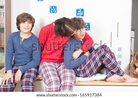 The European family, mother and two sons, in pajamas, sitting on the stove, my mother hugging her son glasses, the second son looking away