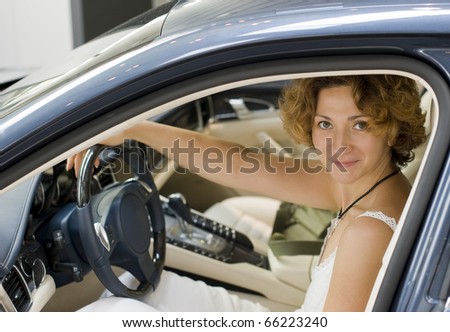 A woman driving a black car